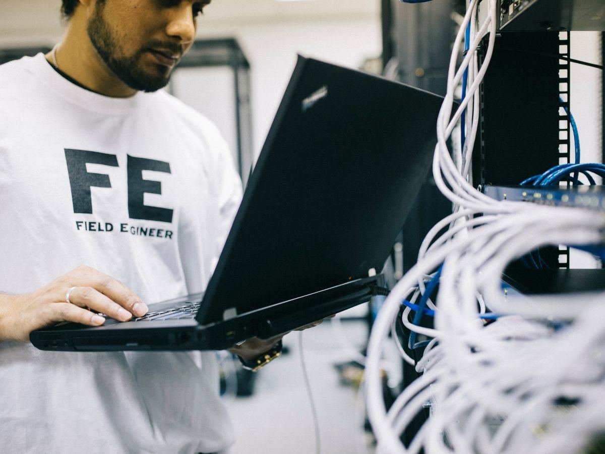 Network engineer working on structured cabling in a server rack