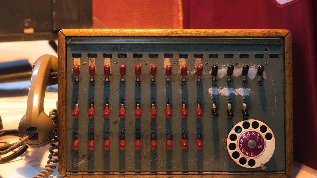 A vintage telephone switchboard with a rotary dial